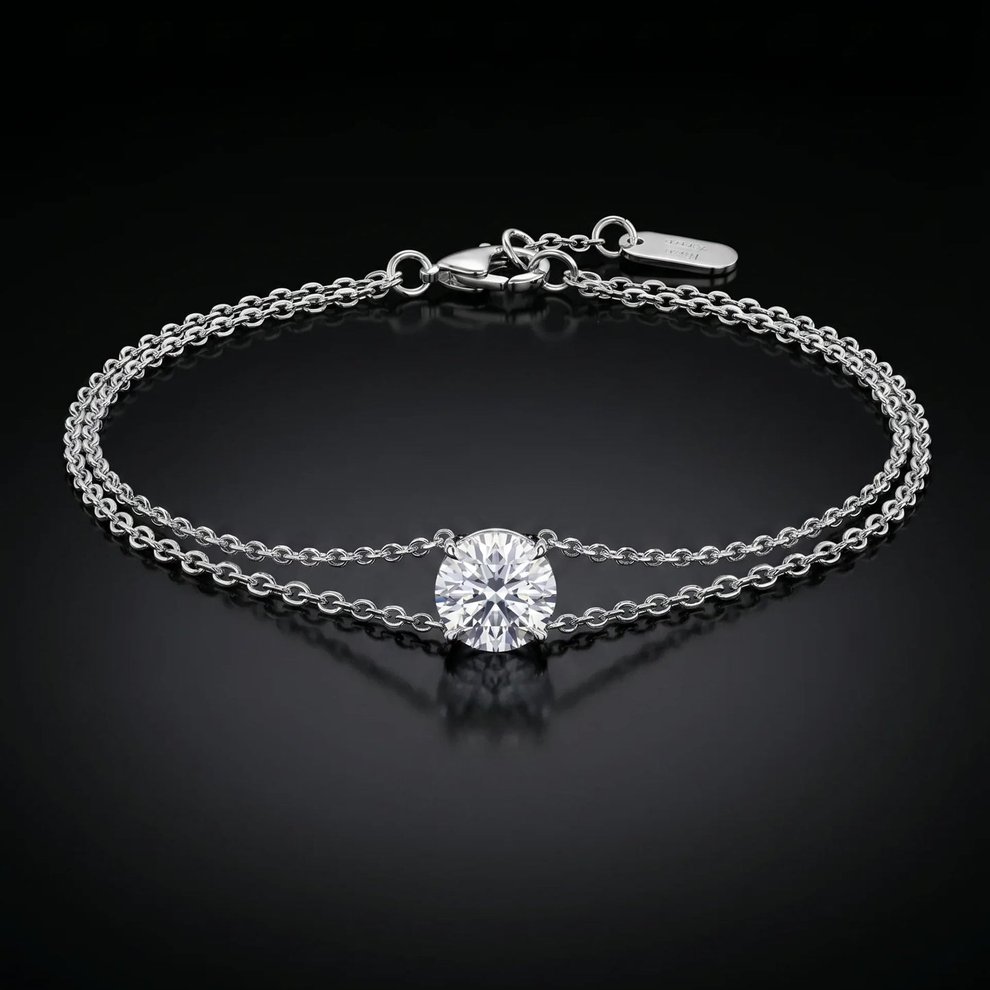 white gold bracelet with a single diamond on a black background