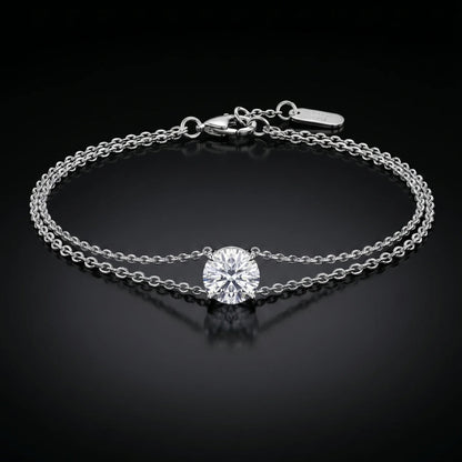 white gold bracelet with a single diamond on a black background