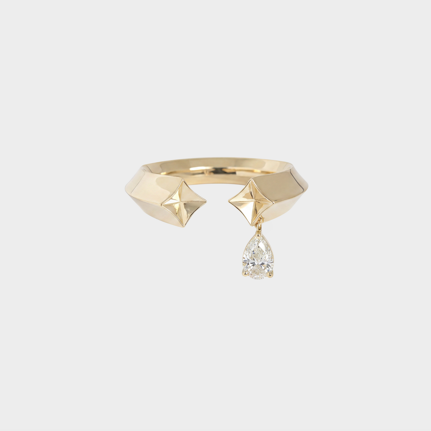 Gold ring with geometric design and teardrop-shaped diamond