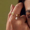 Gold ring with geometric design and teardrop-shaped diamond