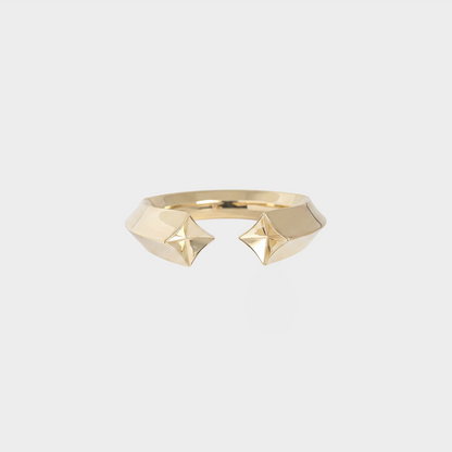 Gold ring with geometric design on a light gray background