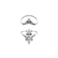 Two white gold rings with diamond-like stones on a white background