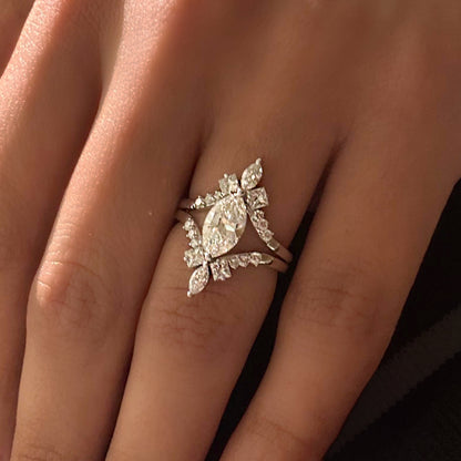 White gold ring with a diamond design on a person's finger