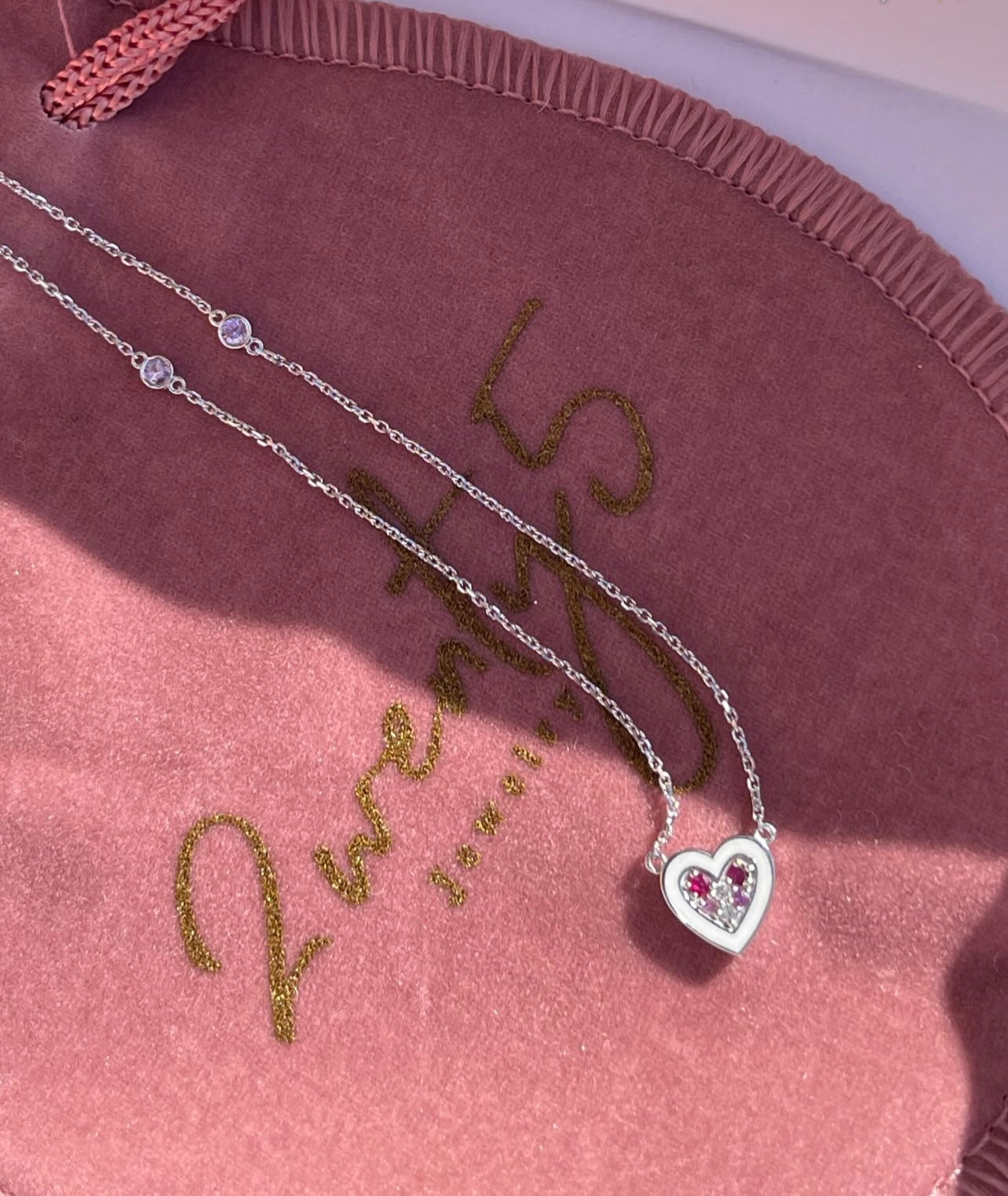 By2wenty5 Heart Choker designs styled on a pink jewellery pouch