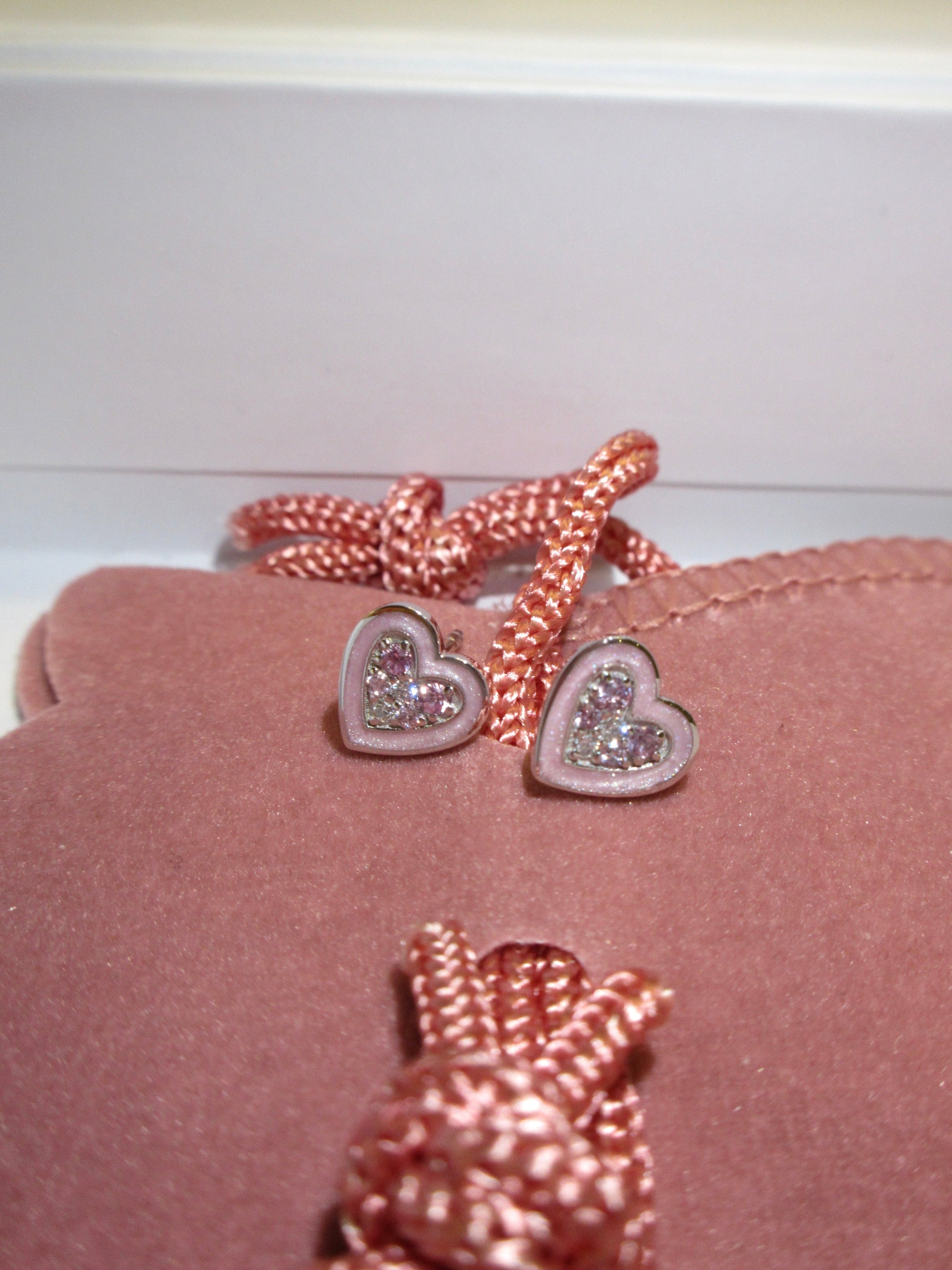 By2wenty5 Heart Studs styled on a pink jewellery pouch