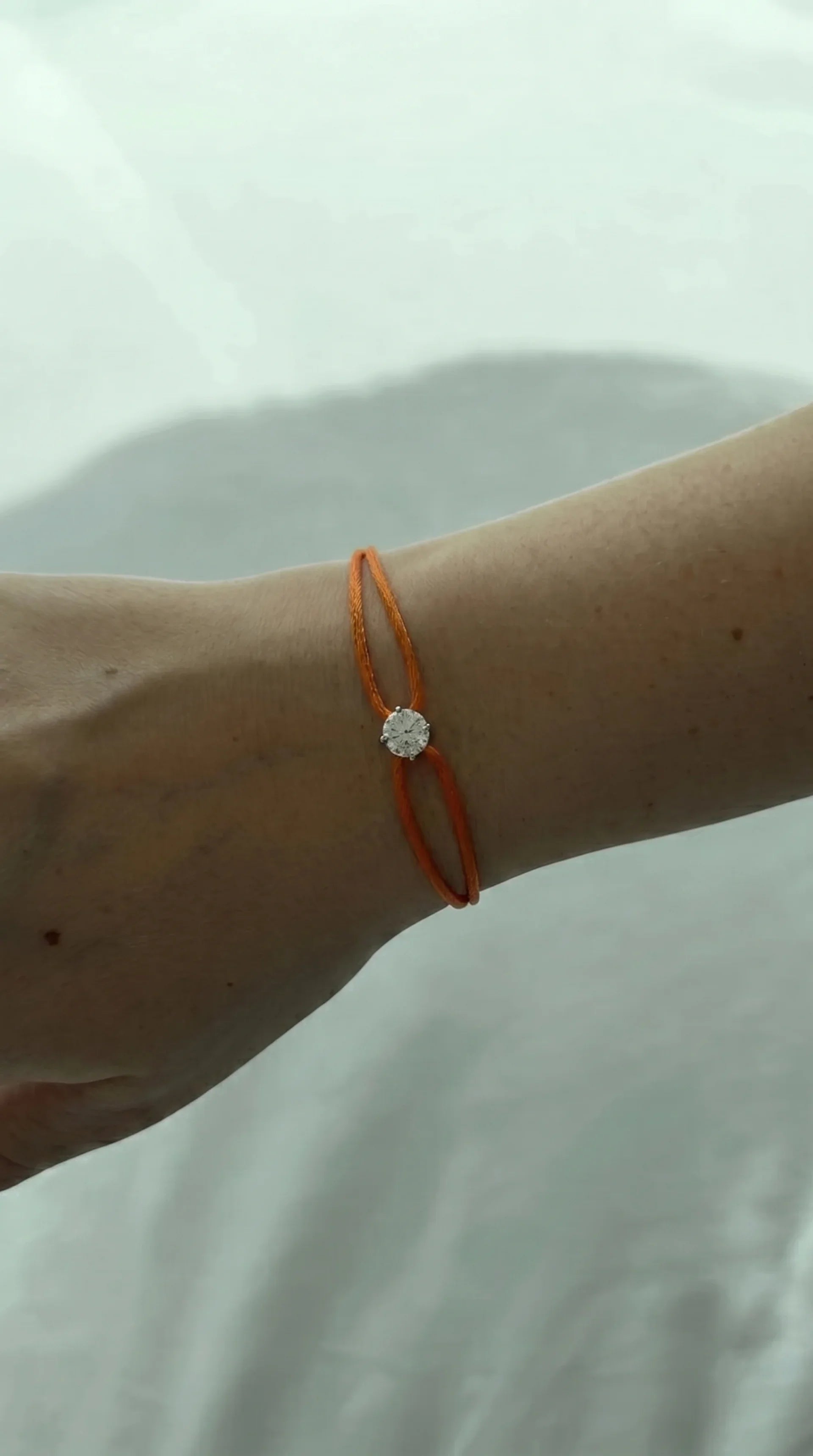 Satin Cord Bracelet in orange, lifestyle view