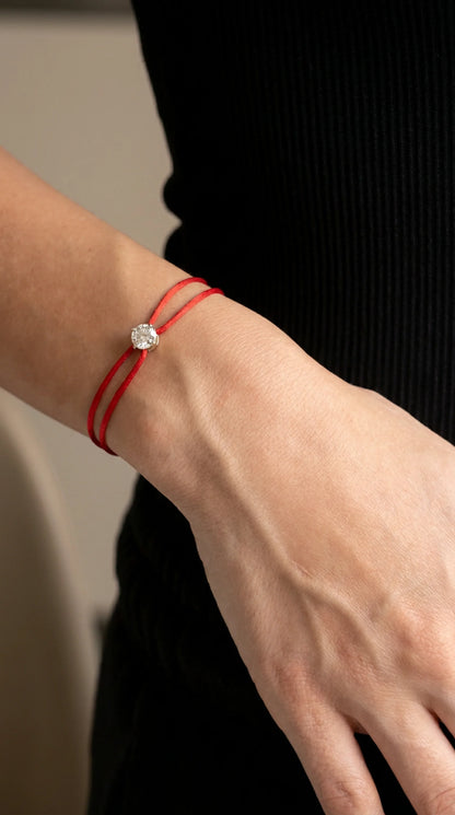 Satin Cord Bracelet in red, worn on hand