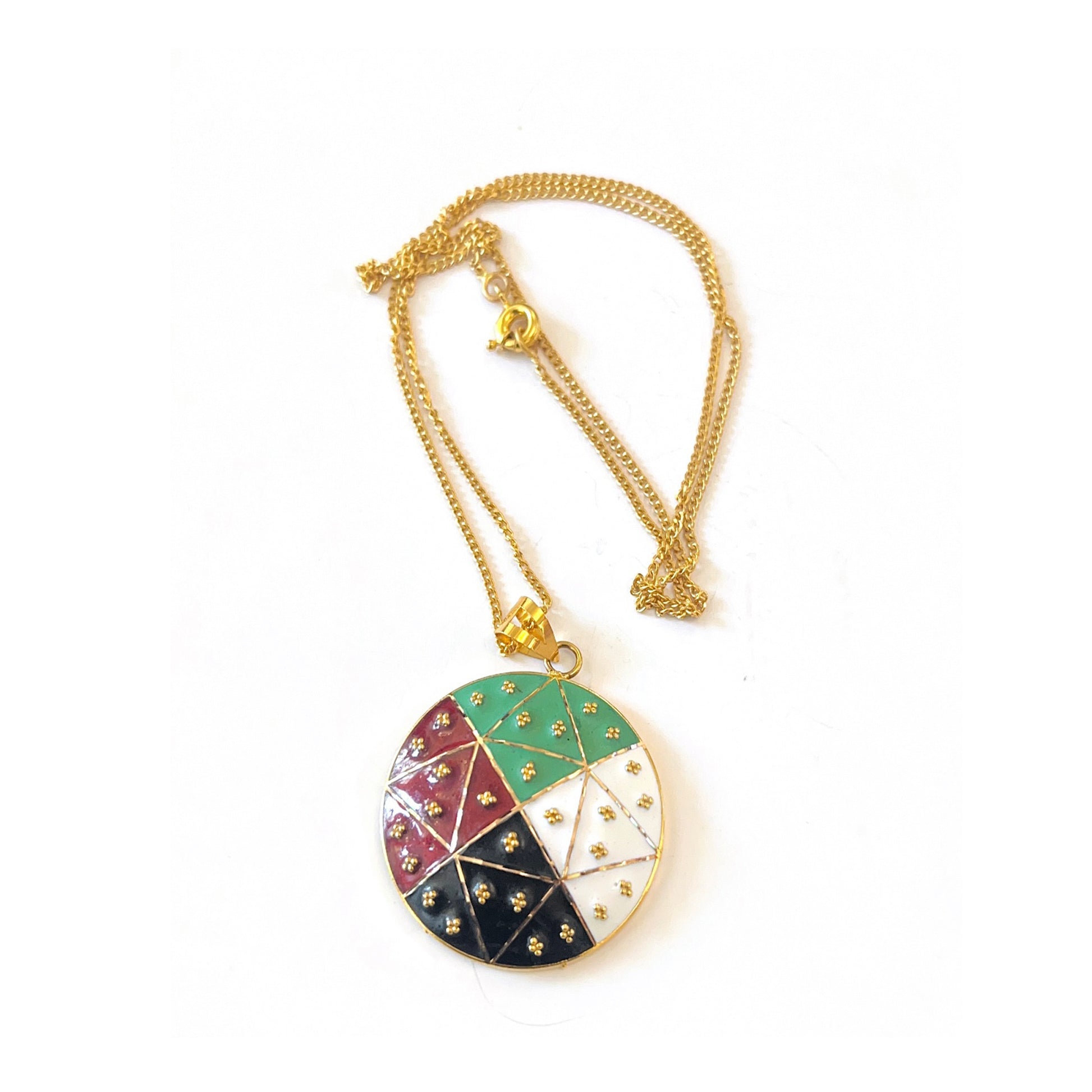 Gold necklace with a colorful pendant on a white background