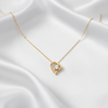 Eternal Heart Pendant in yellow gold, styled on white satin