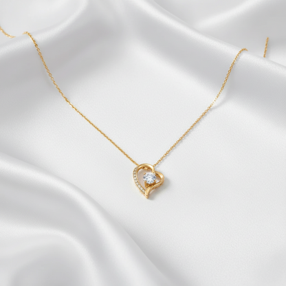 Eternal Heart Pendant in yellow gold, styled on white satin