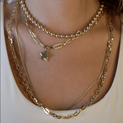 Gaia Gold Star Paperclip Necklace in 18K yellow gold layered on model