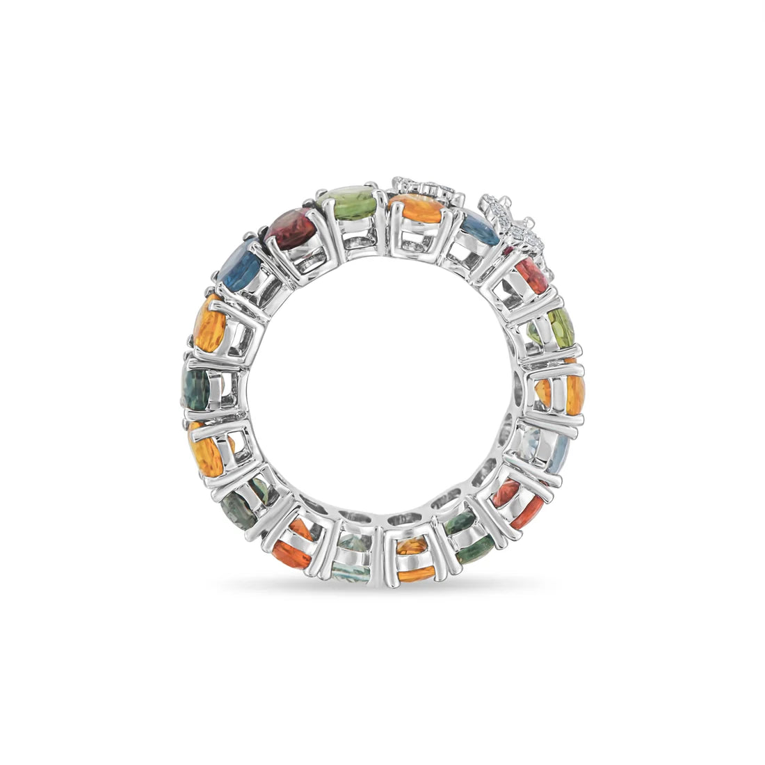 White gold ring with multicolored gemstones on a white background