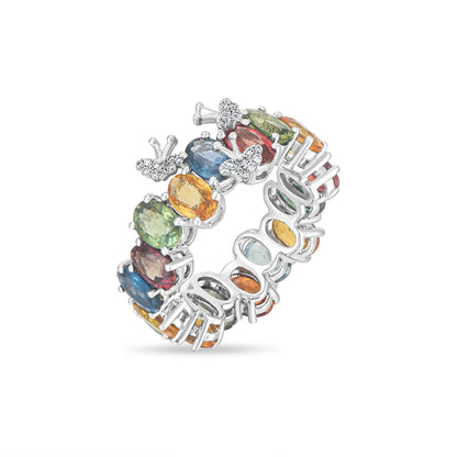 Multicolored gemstone ring with butterfly design on a white background