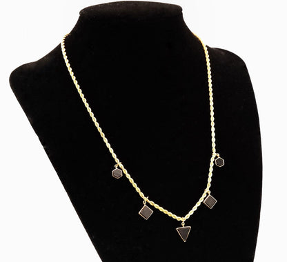 Necklace with geometric pendants on a black mannequin bust
