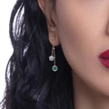 Close-up of a person wearing earrings with a white background