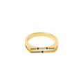 Gold ring with embedded stones on a light beige background