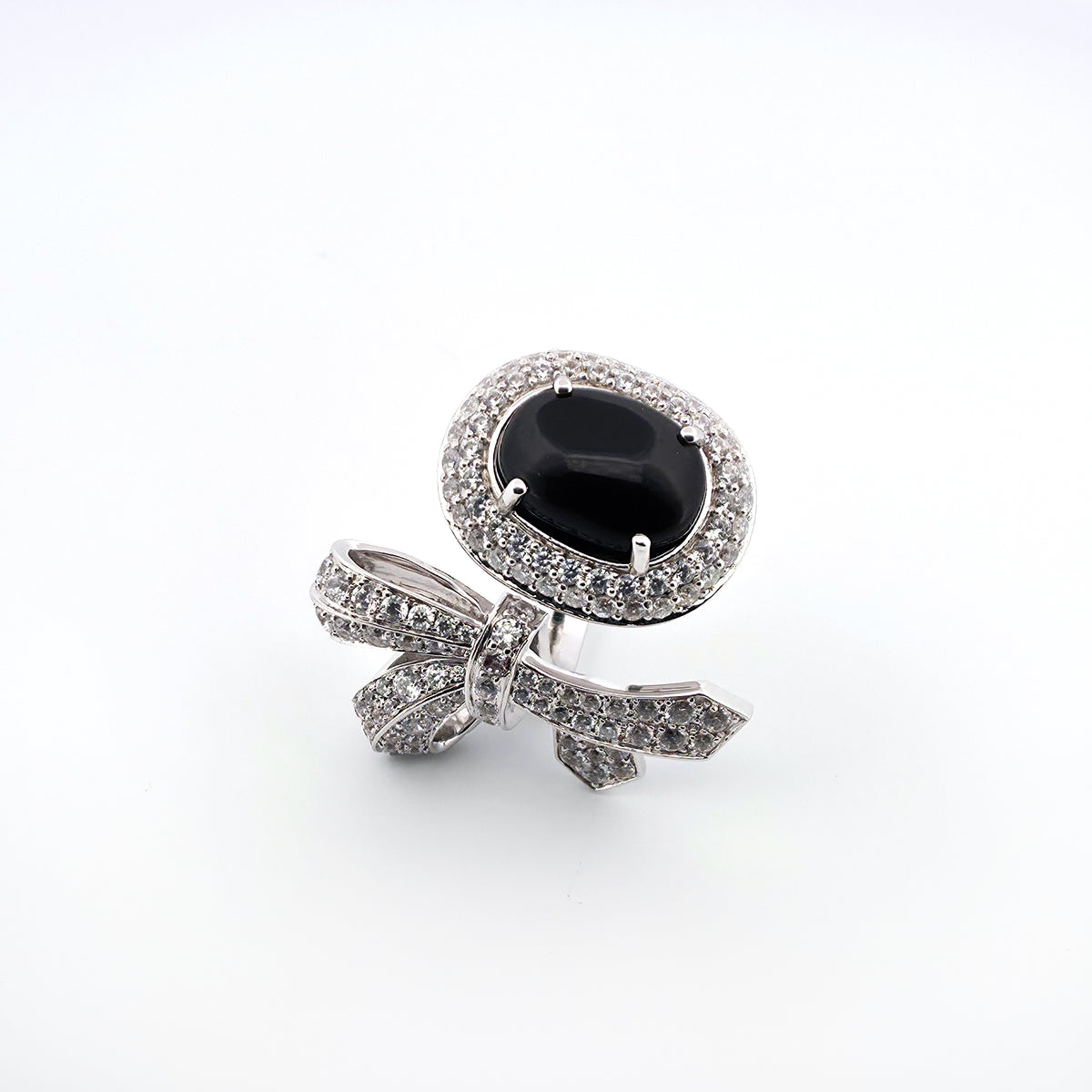 White gold ring with a black gemstone on a white background
