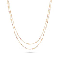 Two-layered necklace with multicolored pearls on a white background
