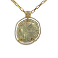 Gold necklace with a coin pendant on a white background