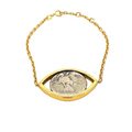 Gold bracelet with a coin eye design on a white background