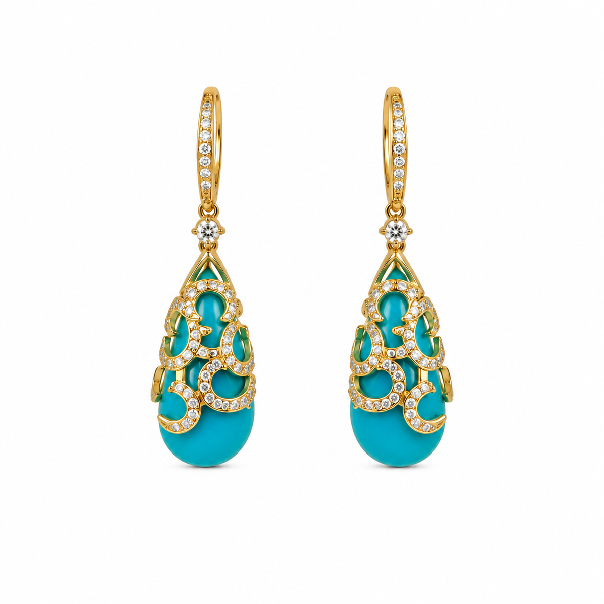 Pair of turquoise earrings with gold and diamond accents on a white background