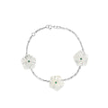 18k white gold bracelet with three mother of pearl star flowers and emeralds