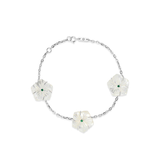 18k white gold bracelet with three mother of pearl star flowers and emeralds