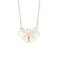 Butterfly-shaped pendant necklace with gold frame and white stones on a white background