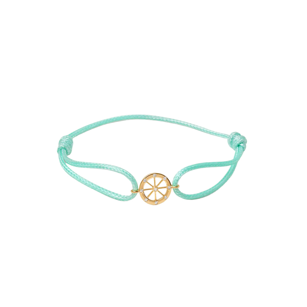 Turquoise bracelet with a gold charm on a white background