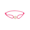 Pink bracelet with a gold charm on a white background