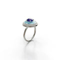 18k white gold ring with tanzanite, diamond halo, and sky blue enamel