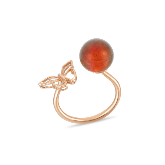 Rose gold ring with a red gemstone on a white background