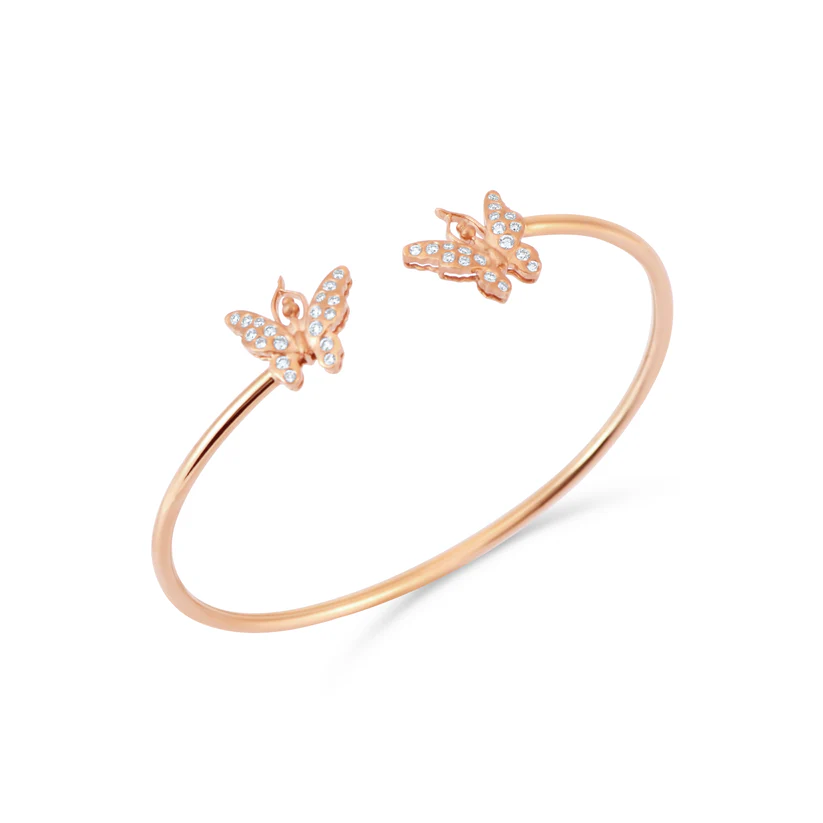 Rose gold bracelet with butterfly charms on a white background