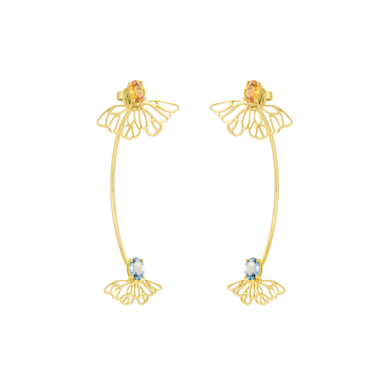 Gold hoop earrings with gemstones on a white background