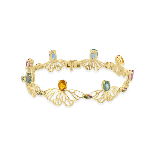 Gold bracelet with gemstones on a white background