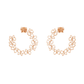 Rose gold floral hoop earrings on a white background