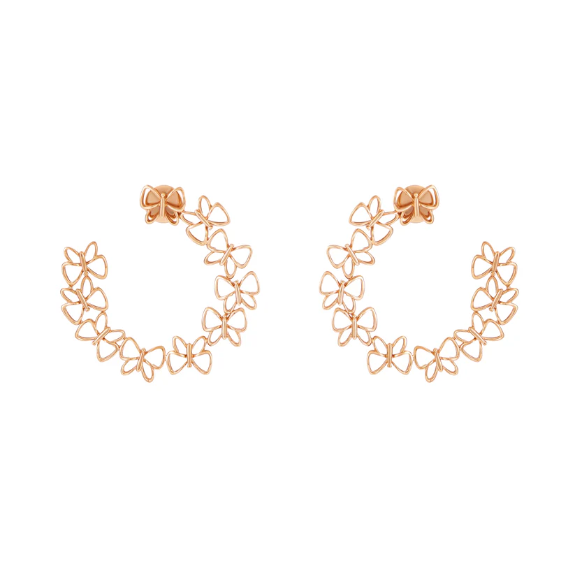 Rose gold floral hoop earrings on a white background