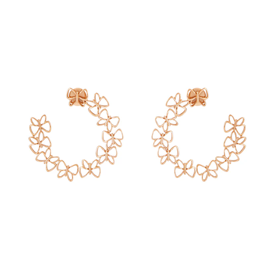 Rose gold floral hoop earrings on a white background