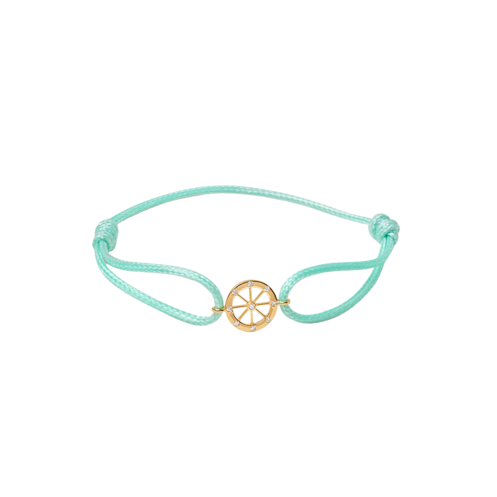 Turquoise bracelet with a gold charm on a white background