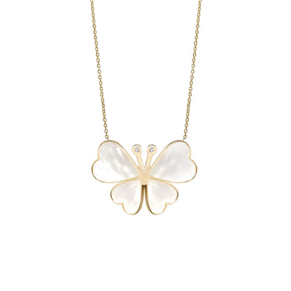 Butterfly-shaped pendant necklace with gold frame and white stones on a white background