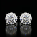 Pair of diamond stud earrings on a black background