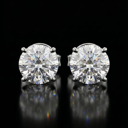 Pair of diamond stud earrings on a black background