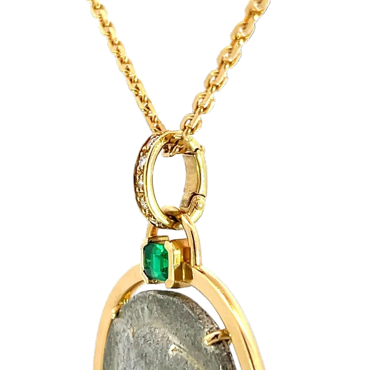Gold necklace with a pendant featuring a green gemstone and gray stone on a white background