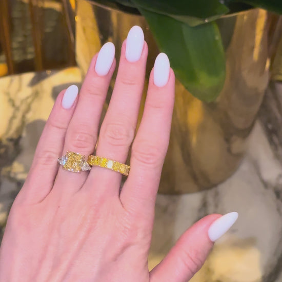 Verbesa Atelier Fancy Yellow cushion diamond ring worn with yellow diamond eternity ring