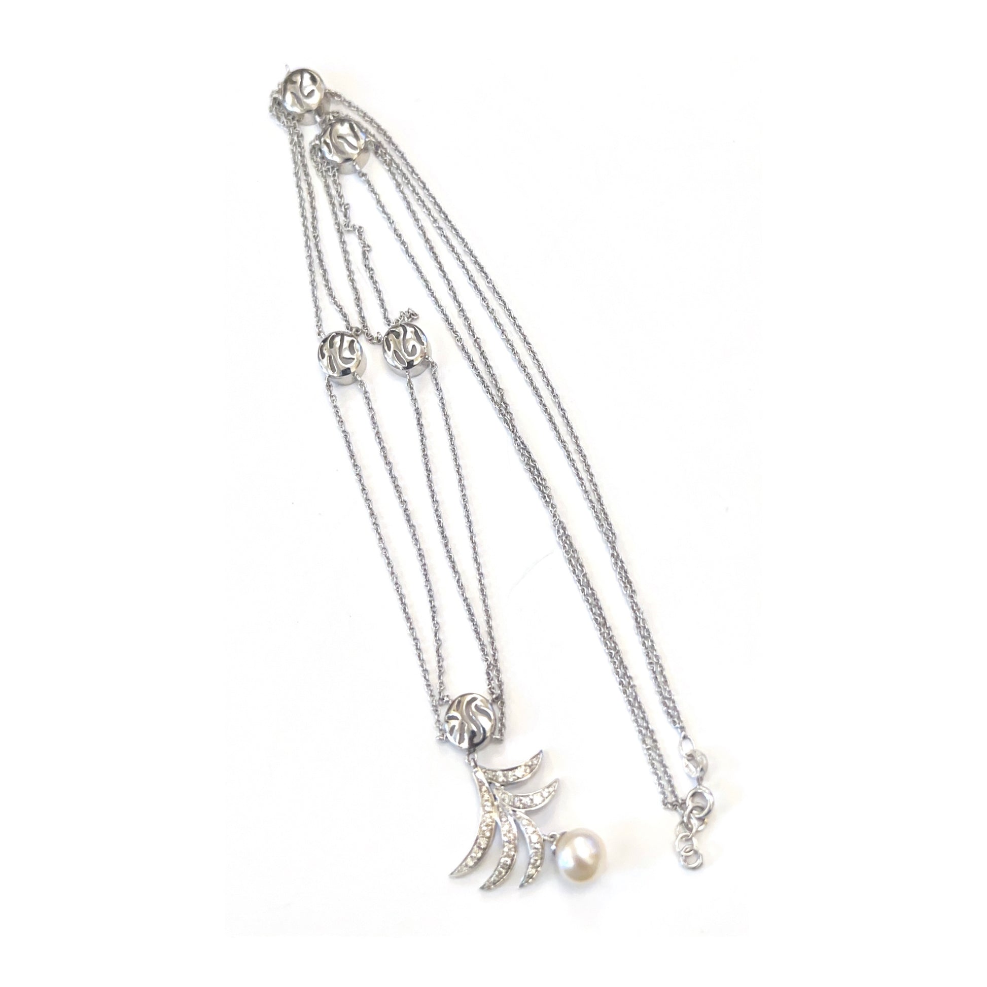 White gold bracelet with multiple charms on a white background