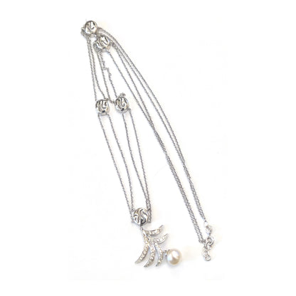 White gold bracelet with multiple charms on a white background