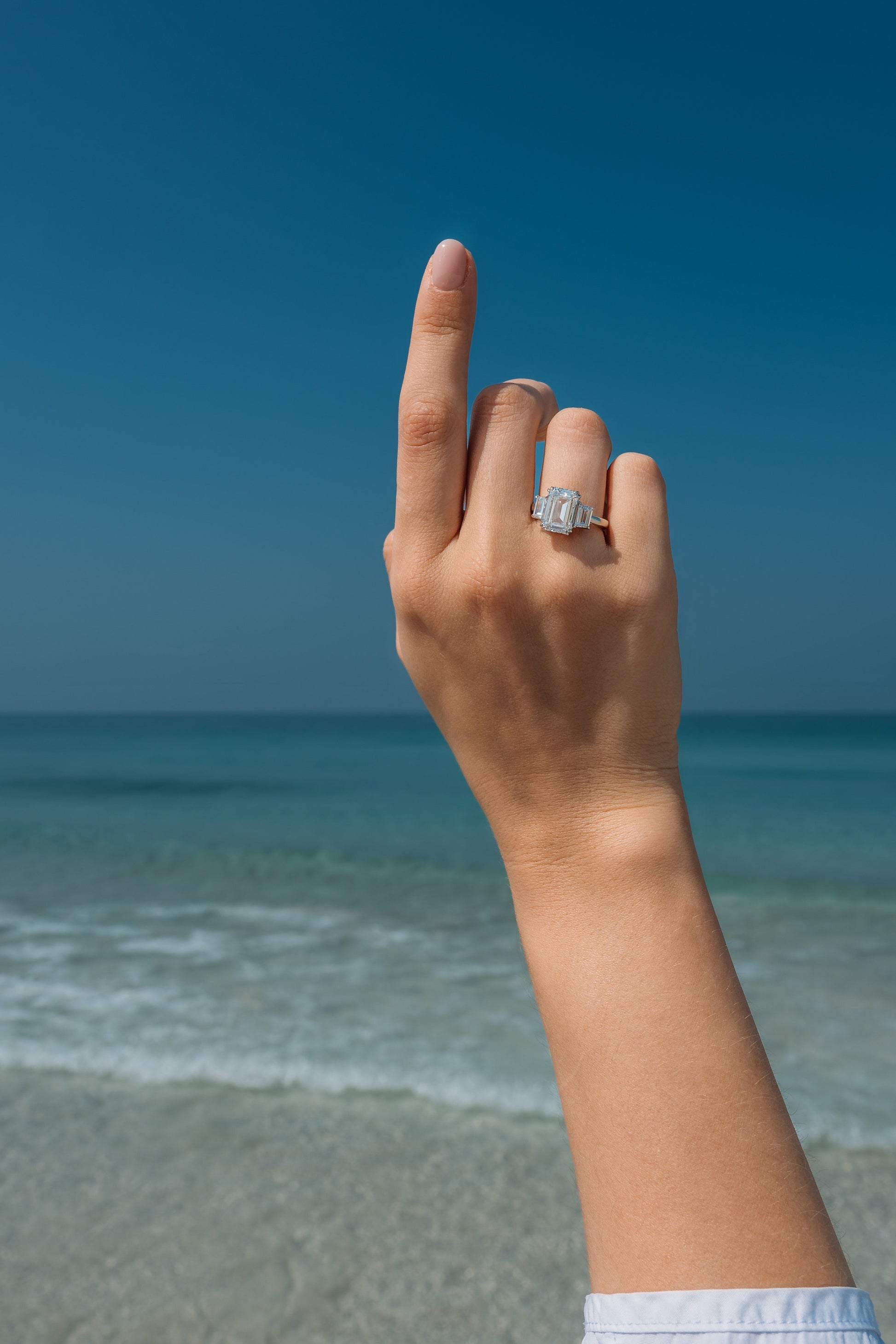 Model wearing Verbesa Atelier emerald-cut lab-grown diamond three-stone engagement ring