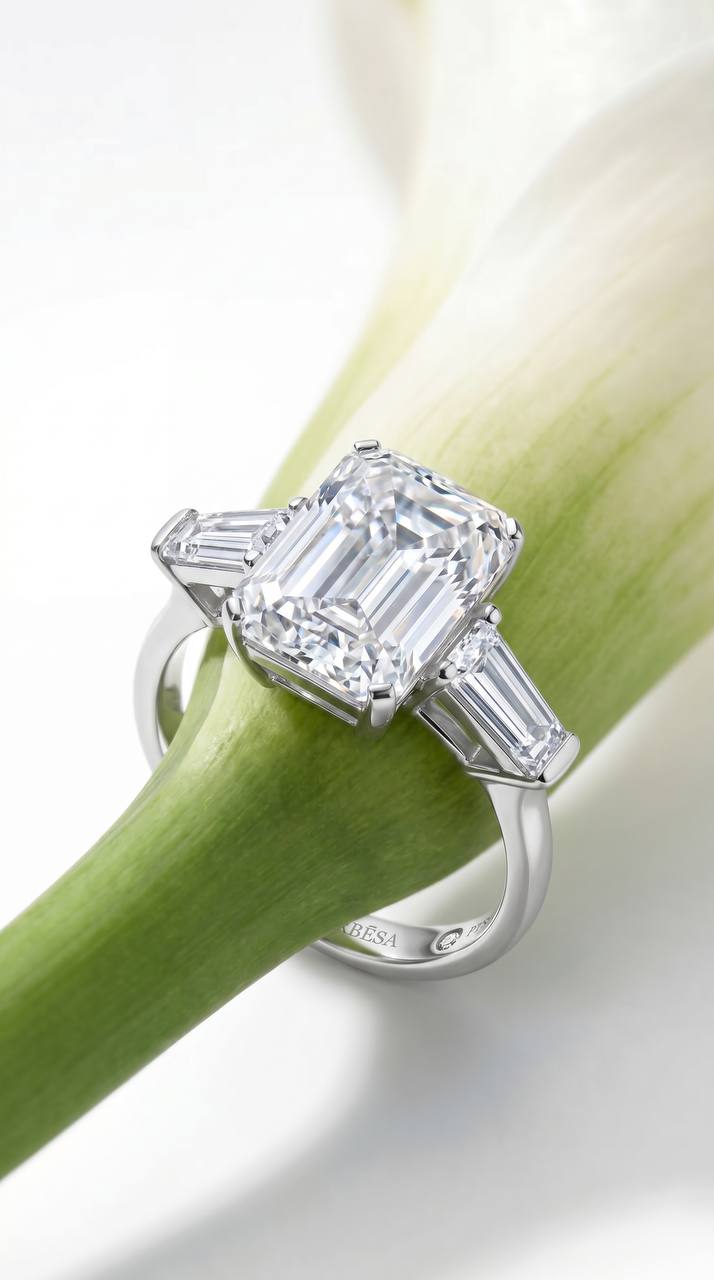 Verbesa Atelier emerald-cut lab-grown diamond three-stone engagement ring styled on a white flower