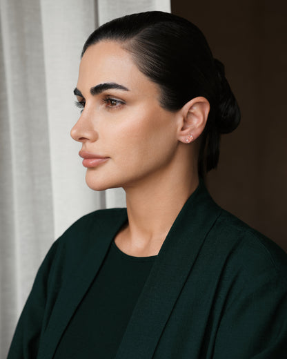 Model wearing Verbesa Atelier fancy pink cushion-cut lab-grown diamond stud earrings