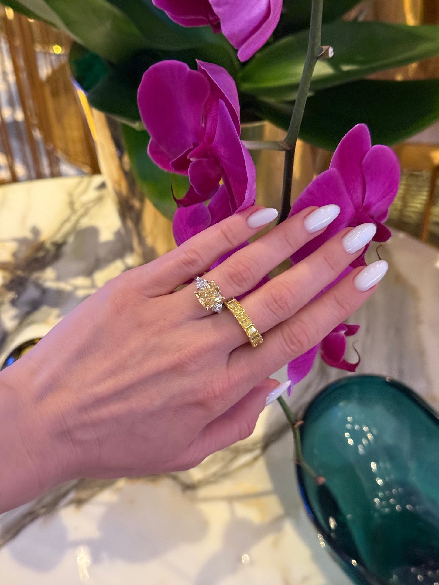 Verbesa Atelier fancy yellow cushion lab-grown diamond ring worn with a yellow diamond eternity ring